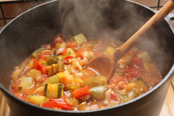 Ratatouille being cooked in a cast iron casserole  French cooking stock photo