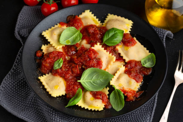 Ravioli with tomato sauce on plate stock photo