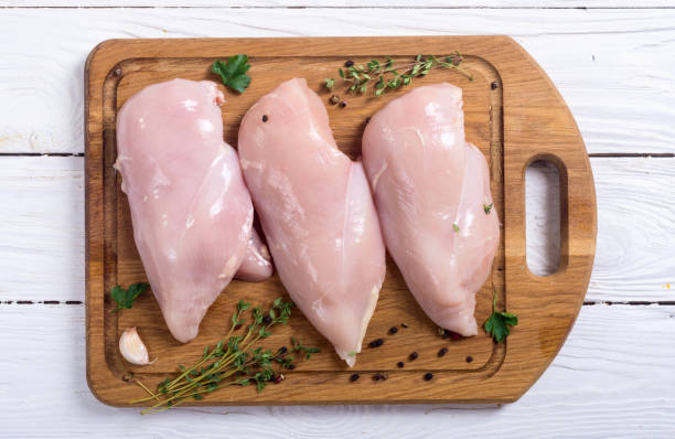 Raw chicken breast with spices stock photo