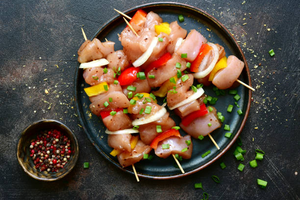 Raw chicken kebab with ingredients for marinating stock photo