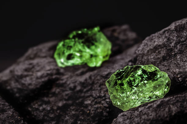 raw emerald gem in rare stone mine, bright green stone stock photo