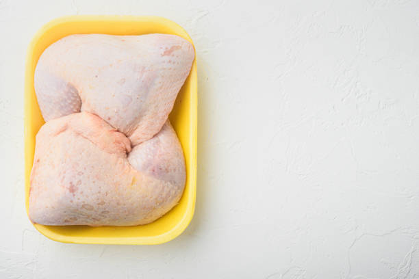 Raw fresh chicken thight or leg, in Foam Tray Pack, on white stone  background, top view flat lay, with copy space for text Raw fresh chicken thight or leg set, in Foam Tray Pack, on white stone  background, top view flat lay, with copy space for text chicken thigh meat stock pictures, royalty-free photos & images
