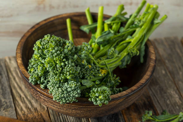 Raw Green Organic Broccolini Raw Green Organic Broccolini REady to Cook With broccoli rabe stock pictures, royalty-free photos & images