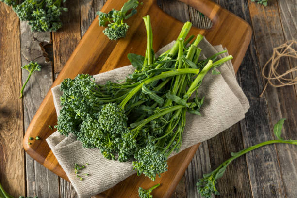 Raw Green Organic Broccolini Raw Green Organic Broccolini REady to Cook With broccoli rabe stock pictures, royalty-free photos & images