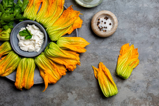 Raw Ingredients for cooking Zucchini Flowers stuffed with ricotta cheese and parsley.Courgette or pumpkin flowers. stock photo