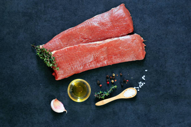 raw lamb and ingredients on a black background stock photo