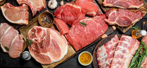 Raw meat. Different kinds of pork and beef meat. Raw meat. Different kinds of pork and beef meat. On a black rustic background. meat stock pictures, royalty-free photos & images