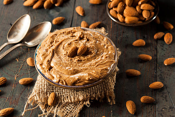 Raw Organic Almond Butter Raw Organic Almond Butter on a Background almond butter stock pictures, royalty-free photos & images