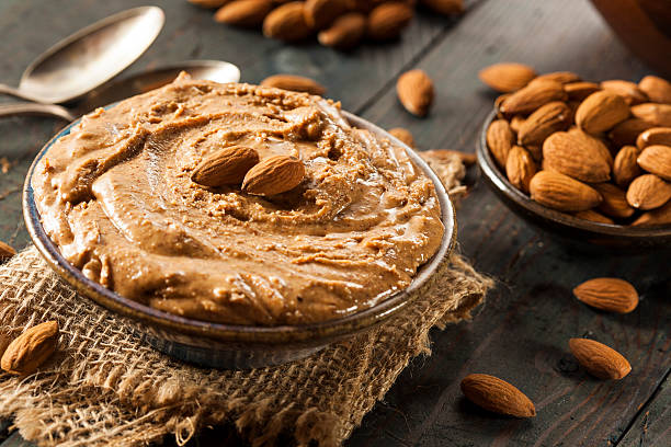 Raw Organic Almond Butter Raw Organic Almond Butter on a Background almond butter stock pictures, royalty-free photos & images