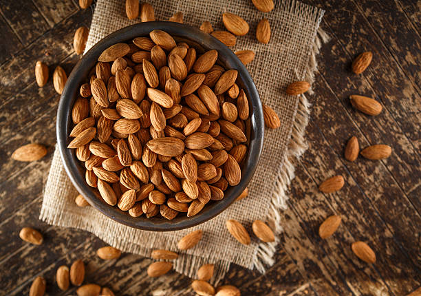 Raw Organic Almonds Raw Organic Almonds Photographed on a Piece of Burlap almond photos stock pictures, royalty-free photos & images