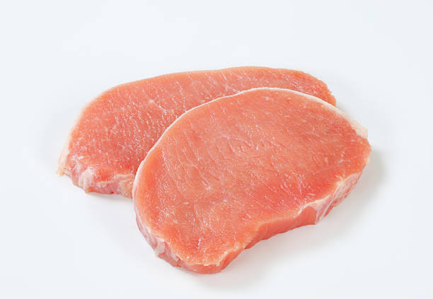 raw pork loin chops two raw boneless pork loin chops on a white background pork stock pictures, royalty-free photos & images