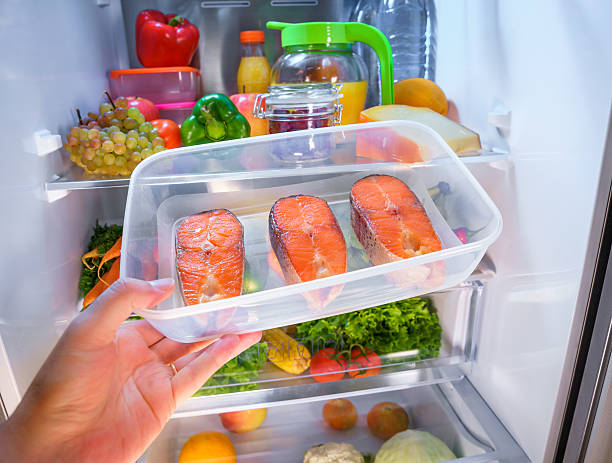 Raw Salmon steak in the open refrigerator stock photo