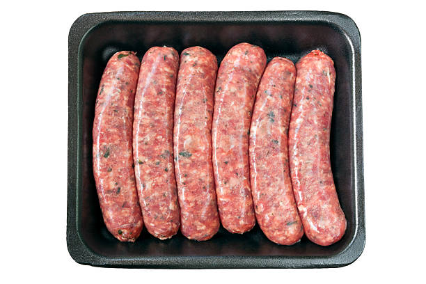 Raw Sausages on Tray Isolated Raw sausages on styrofoam tray, isolated on white. sausage stock pictures, royalty-free photos & images