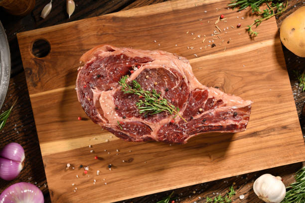 Raw steak meat beef on wooden chopping board stock photo