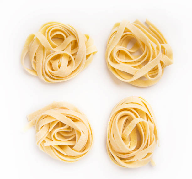 Raw tagliatelle nest isolated on white Raw tagliatelle nests isolated on white background. Traditional Italian pasta tagliatelle stock pictures, royalty-free photos & images