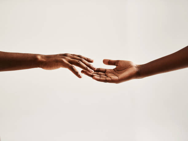 Reach out to someone Closeup shot of two unrecognisable people reaching for each other with their hands touching stock pictures, royalty-free photos & images