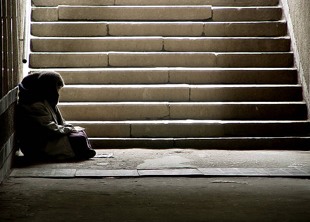 Read photo of beggar woman reading the book in undergrund subway homelessness stock pictures, royalty-free photos & images