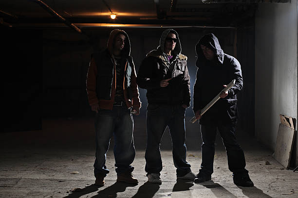 Ready for a fight Gang members in a dark alley gang stock pictures, royalty-free photos & images