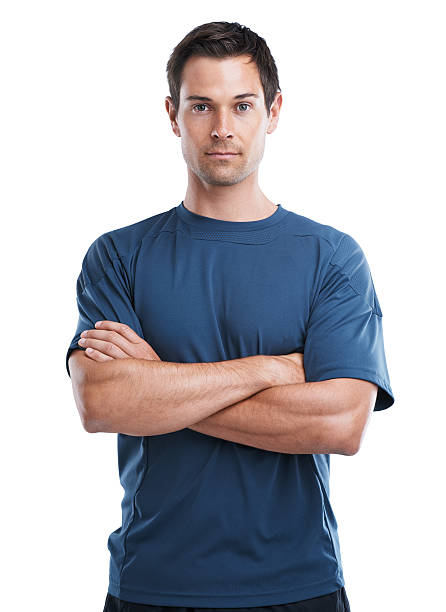Studio portrait of a handsome young man in sports clothing standing with his arms crossed