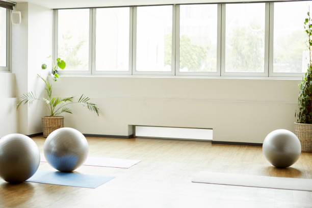 Cropped shot of a group of yoga balls and mats laid out before a baby yoga class in the studio