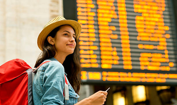 Young woman checking her train in time board