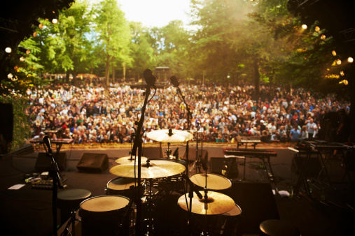 Shot of musical instruments on a stage looking out over a huge crowd