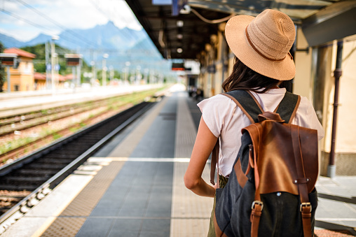 Photo of a female traveler waiting the train