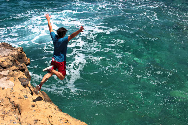 Ready to make the leap cliff jumping in Greece Freedom Being free cliff jumping stock pictures, royalty-free photos & images