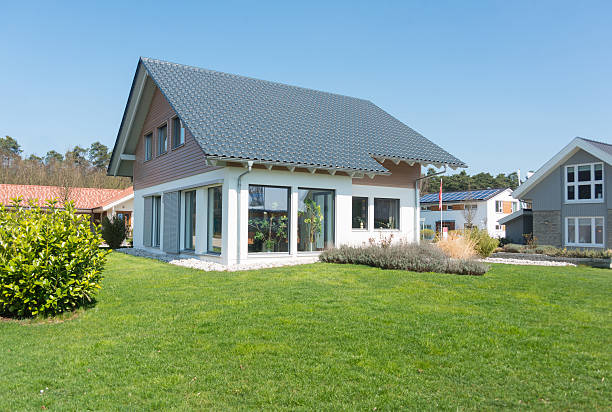 real estate home with garden meadow - Einfamilienhaus Nuremberg, Germany - March 29, 2014: home with garden. Picture taken in "Fertighauspark" near Nuremberg/Erlangen in Germany. It's a demohouse with no real people live in there. prefabricated building stock pictures, royalty-free photos & images