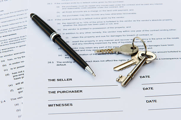 Real estate sales contract with keys and pen stock photo
