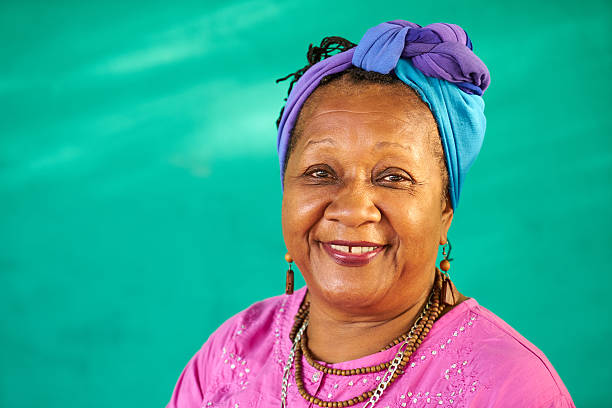 Real People Portrait Old Black Woman Smiling At Camera Old Cuban people and emotions, portrait of senior african american lady laughing and looking at camera. Happy elderly black woman from Havana, Cuba smiling antilles stock pictures, royalty-free photos & images