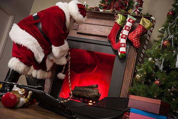 real santa ziehen geschenktasche von kamin - fett verbrennen senior stock-fotos und bilder