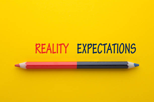 Reality Expectations Concept The words Expectation vs Reality with pencil on yellow background. real life stock pictures, royalty-free photos & images