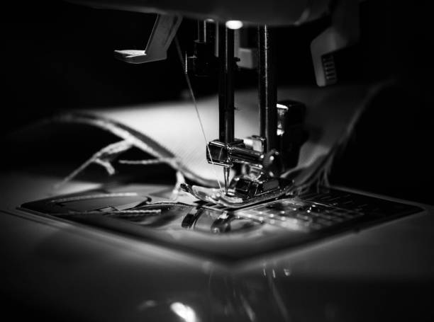 Reap What You Sew A needle from a sewing machine stitches a piece of fabric. textile industry photos stock pictures, royalty-free photos & images