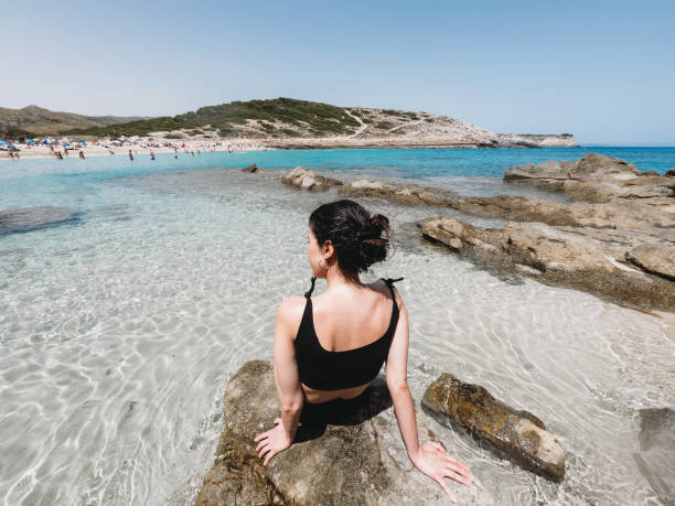 Rear view of a beautiful woman in the sea stock photo