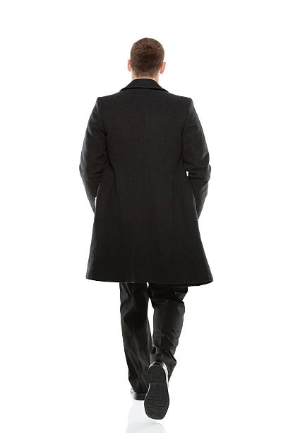 Rear view of a businessman walking stock photo