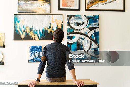 istock Rear view of a guy in his 30s looking at an art exhibition 1294597310