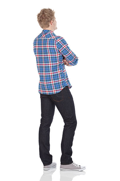 Rear view of a man standing with arms crossed Rear view of a man standing with arms crossedhttp://www.twodozendesign.info/i/1.png behind stock pictures, royalty-free photos & images