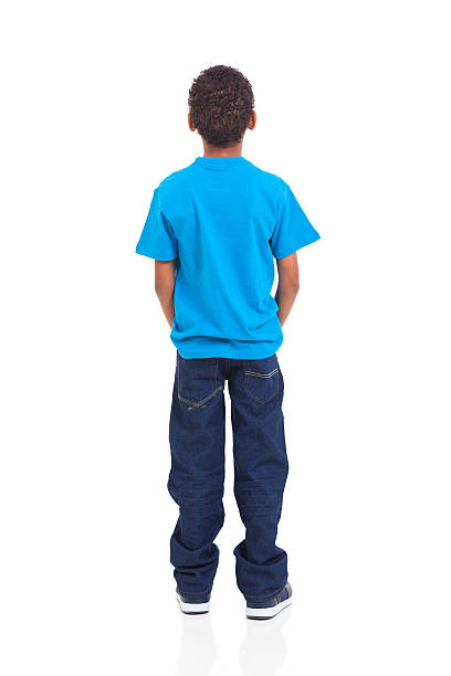 Rear view of African American boy on white rear view of african american boy isolated on white background rear view stock pictures, royalty-free photos & images