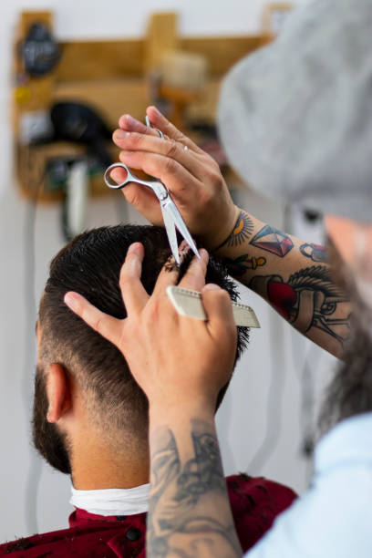 Rear view of barber cutting hair stock photo