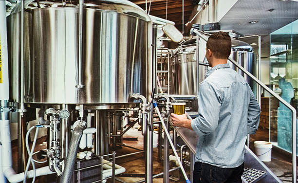 Rear view of brewmaster at factory stock photo