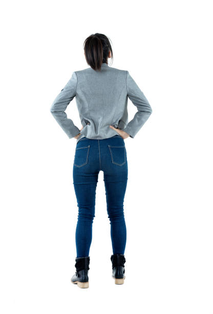 Rear view of businesswoman standing Rear view of businesswoman standing. hand on hip stock pictures, royalty-free photos & images