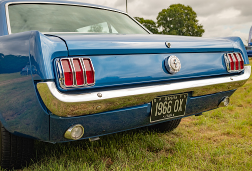 Festival of Wheels, Ipswich - 2013 July 20201. Close up of the rear of a classic and retro Ford Mustang muscle car on public display in the town.