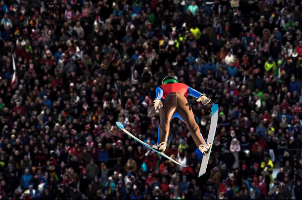 Rear View of Male Ski Jumper in Mid-air stock photo