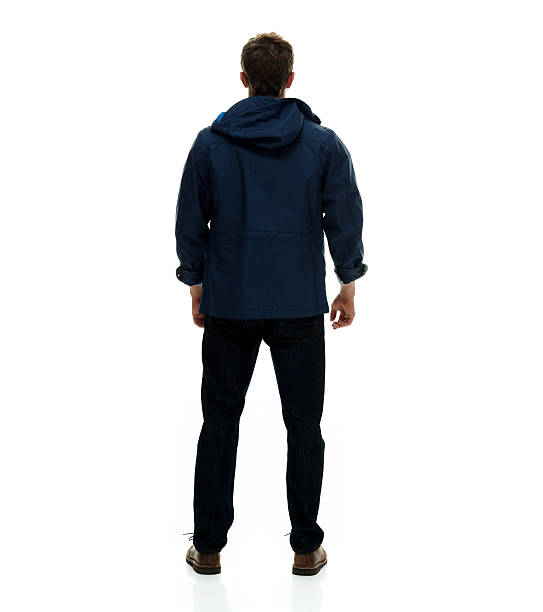 Rear view of man standing and looking away stock photo