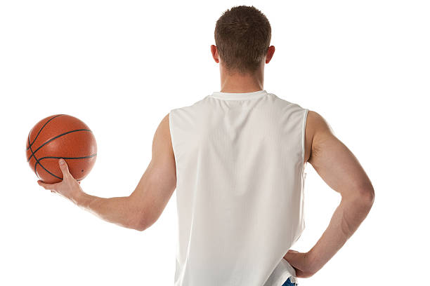 rear view of sportsman holding a basketball - basketball player back stockfoto's en -beelden