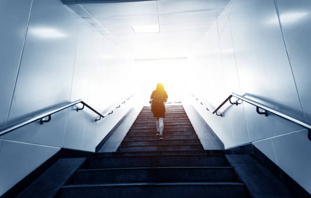 rear view of woman climbing the staircases - stairs subway imagens e fotografias de stock