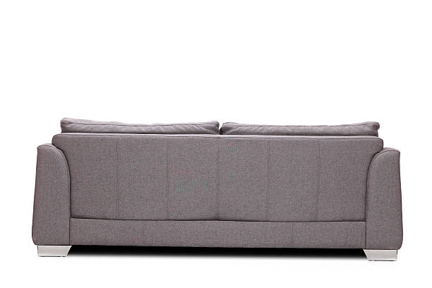 Rear view studio shot of a modern gray sofa Rear view studio shot of a modern gray sofa isolated on white background behind stock pictures, royalty-free photos & images