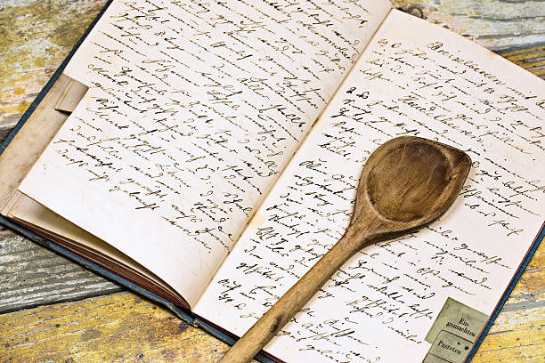 Recipe book with wooden spoon Grandmothers cookbook with spoon on the kitchen table recipe stock pictures, royalty-free photos & images