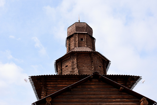 Reconstruction of an ancient watchtower built of logs with a high dome on top.